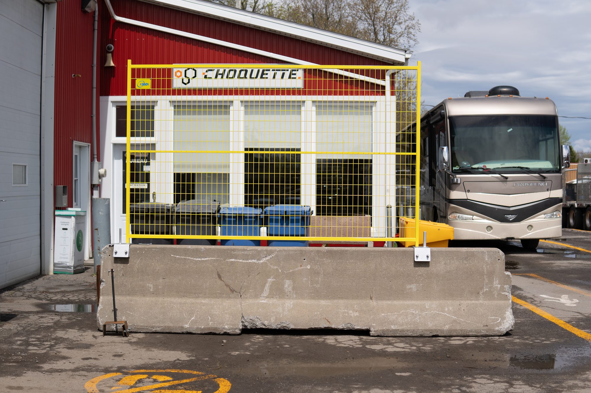 Construction fence mounted on a concrete Jersey barrier